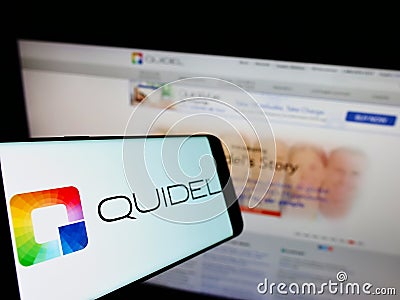 Smartphone with logo of US diagnostics company Quidel Corporation on screen in front of business website. Editorial Stock Photo