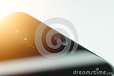 Smartphone micro speaker above the screen close-up. The top of the mobile phone with a built-in camera and speaker Stock Photo