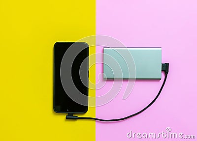Smartphone mobile phones charging batteries by power bank Stock Photo