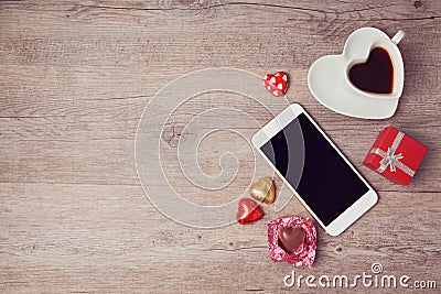 Smartphone mock up flat lay for Valentine's day with coffee cup and chocolate. View from above Stock Photo