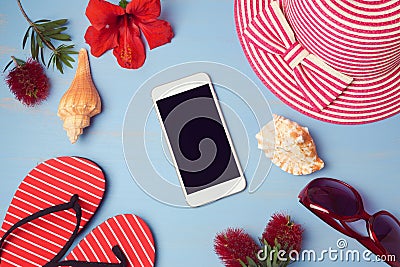 Smartphone mock up template with summer beach items and tropical flowers. View from above. Stock Photo