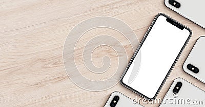 Smartphones like iPhone X mockup banner with copyspace flat lay top view lying on wooden office desk Stock Photo