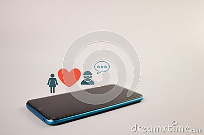 Smartphone with scammer, love and wooden icons Stock Photo