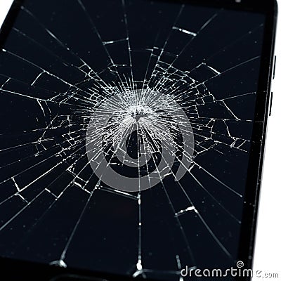 A smartphone screen displaying extensive damage with a spiderweb pattern of cracks Stock Photo