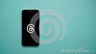 Smartphone screen with the Threads Meta logo on a blue background Editorial Stock Photo