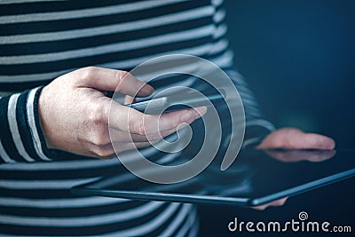 Smartphone and tablet data synchronization, woman syncing files Stock Photo