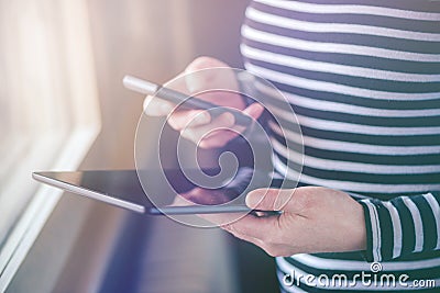 Smartphone and tablet data synchronization, woman syncing files Stock Photo