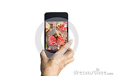 Smartphone take photos of pomegranate on isolated background Stock Photo
