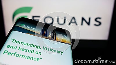 Smartphone with webpage of French facility management company EQUANS on screen in front of business logo. Editorial Stock Photo