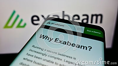 Smartphone with website of American cybersecurity company Exabeam Inc. on screen in front of business logo. Editorial Stock Photo