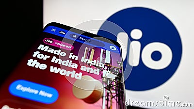 Smartphone with website of Indian telecommunications company Reliance Jio on screen in front of business logo. Editorial Stock Photo