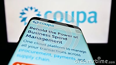 Smartphone with website of spend management company Coupa Software Inc. on screen in front of business logo. Editorial Stock Photo