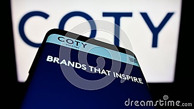 Smartphone with website of US beauty company Coty Inc. on screen in front of business logo. Editorial Stock Photo