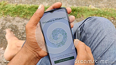 Smartphone in a young man's hand and a WhatsApp conversation. Chat technology WhatsApp. Communication and social networks. Editorial Stock Photo