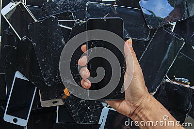 Smartphones and phone screens that are damaged by usage are gathered to be recycled for valuable minerals because e-waste contains Stock Photo