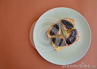 Smashed avocado on toast with portobello mushrooms Stock Photo