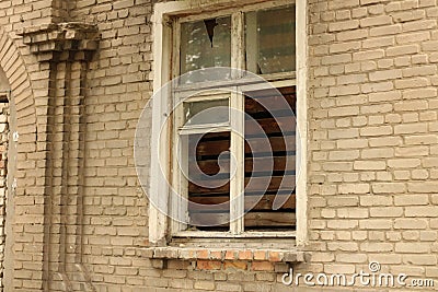 smashed a shot of an old brick building planked window at the Donbass in Ukraine Stock Photo