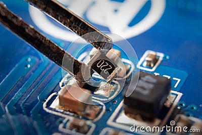 Smd resistor in tweezers Stock Photo