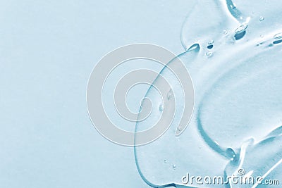 The smear of a transparent gel on a blue background. Stock Photo