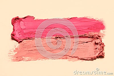 Smears of beautiful lipsticks on beige background, closeup Stock Photo