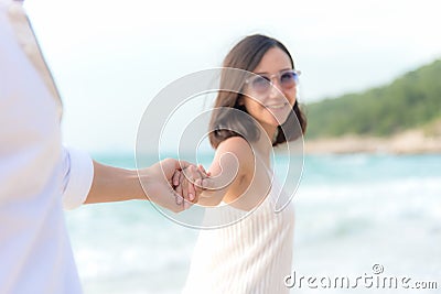 Smelling Couple summer Vacation, Asian young woman holding man hand on the beach, so happy and in love on honeymoon holiday Stock Photo