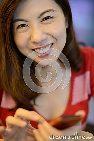 Smile asian woman have fun with mobile phone Stock Photo