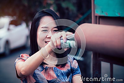 Smile asian woman picked up the newspaper in the morning every day Stock Photo