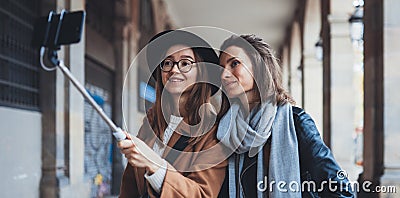 Smile girlfriends taking photo selfie on smartphone mobile. Blogger hipster travels in city. Holiday friendship concept. Travelers Stock Photo