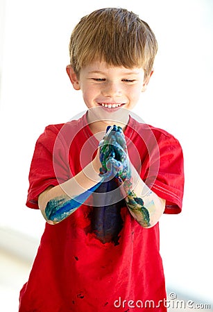 Smile, hands and paint with a boy child at school for art, creative or education as a young student. Children, learning Stock Photo