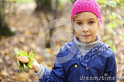Smile little girl holds maple leaf Stock Photo