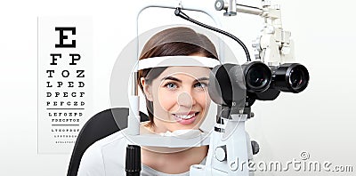 Smile woman doing eyesight measurement with slit lamp and visual Stock Photo