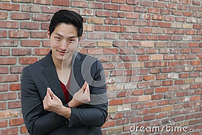 Smiley Asian man making finger heart sign. Korean heart finger sign Stock Photo