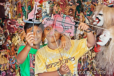 Smiley Balinese children play with shadow puppets Editorial Stock Photo