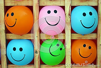 Smiley balls. Group of emotional balls: happy smiley on yellow, pink ,green, blue and orange ball. Stock Photo