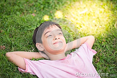 Smiley boy laying down in the park Stock Photo