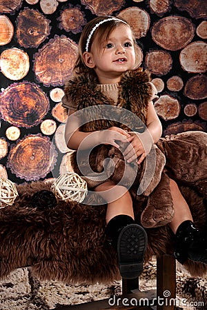 Smiley cute girl with fur vest Stock Photo