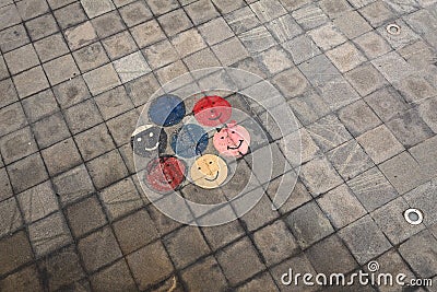 Smiley face colorful drawings on the pavement city smile round face Stock Photo