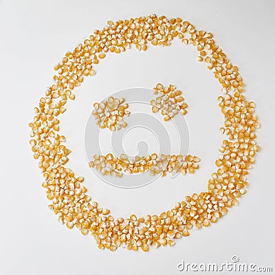 Smiley face made of corn seeds on a white background, emotion neutral Stock Photo