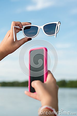 Smiley face with smartphone and sunglasses Stock Photo