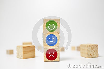 smiley face on wood block cube - business services rating customer experience, Satisfaction survey concept - Feedback Stock Photo