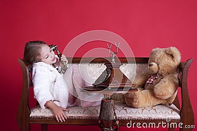 Smiley little girl talking by phone Stock Photo