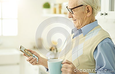 Smiley senior man contacting his therapist via internet Stock Photo