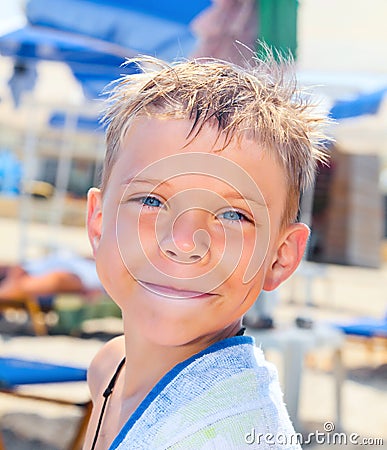 Smiley seven years old boy on the beach Stock Photo