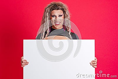 Smiley transgender person holding a blank panel in studio Stock Photo