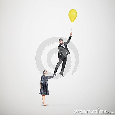 Smiley woman holding flying man Stock Photo