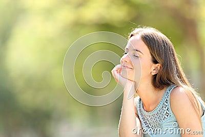 Smiley woman meditating and relaxing in a forest Stock Photo