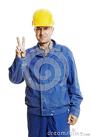 Smiley workman showing victory sign Stock Photo