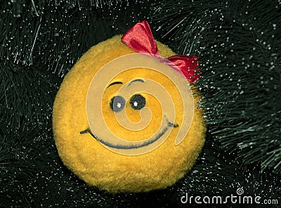 Smiley stuffed toy on the Christmas tree Stock Photo
