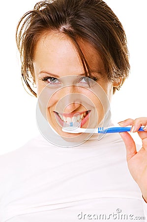 Smiley young woman cleaning her teeth Stock Photo
