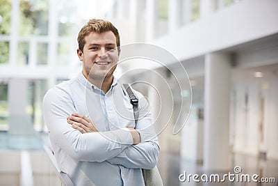 Smiling adult male student in modern university lobby Stock Photo